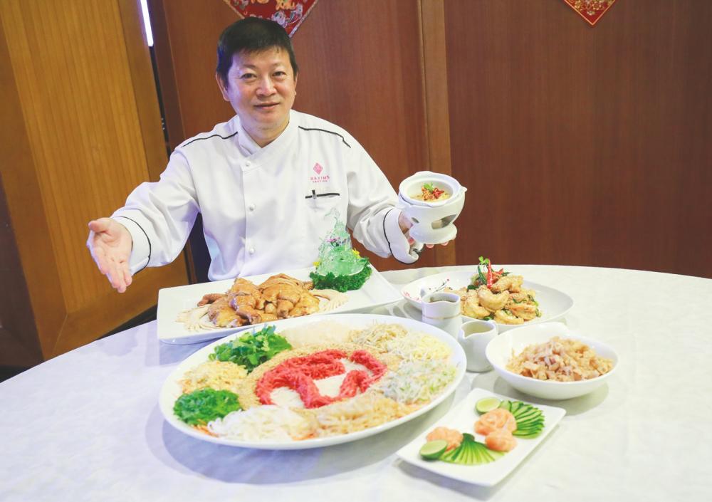 Chef Yap with his Chinese New Year dishes. — Sunpix by Amirul Syafiq