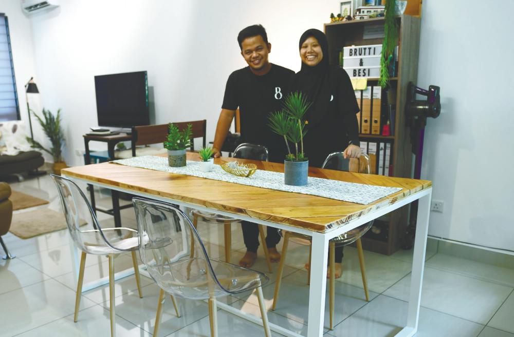 $!Lokman and his wife Siti Faznur showing off the dining table they made. -Bernama