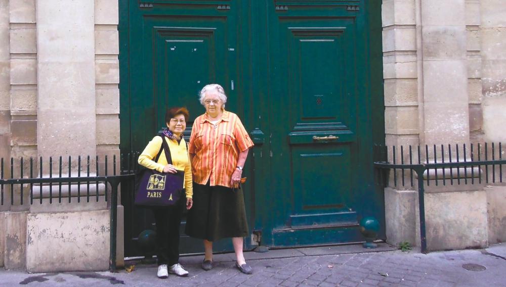Chen (far left) with Sr Elizabeth Sandog, the sister in charge of the archives, at the gate of the historical Mother House at No.12 Rue de L’Abbe Gregoire in Paris. – Chen Yen Ling