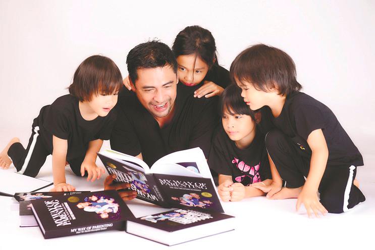 Sheikh Muszaphar reading his new book with his family. –Courtesy of Datuk Dr Sheikh Muszaphar Shukor