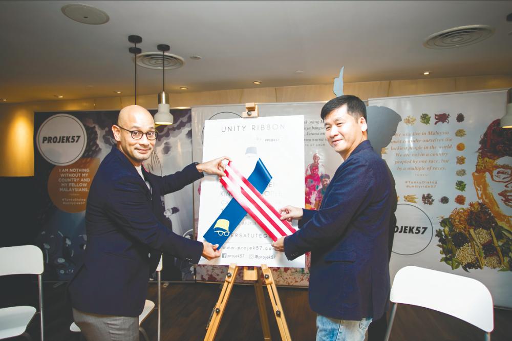 Project57 co-founders Syed Sadiq and Swee with the Unity Ribbon.