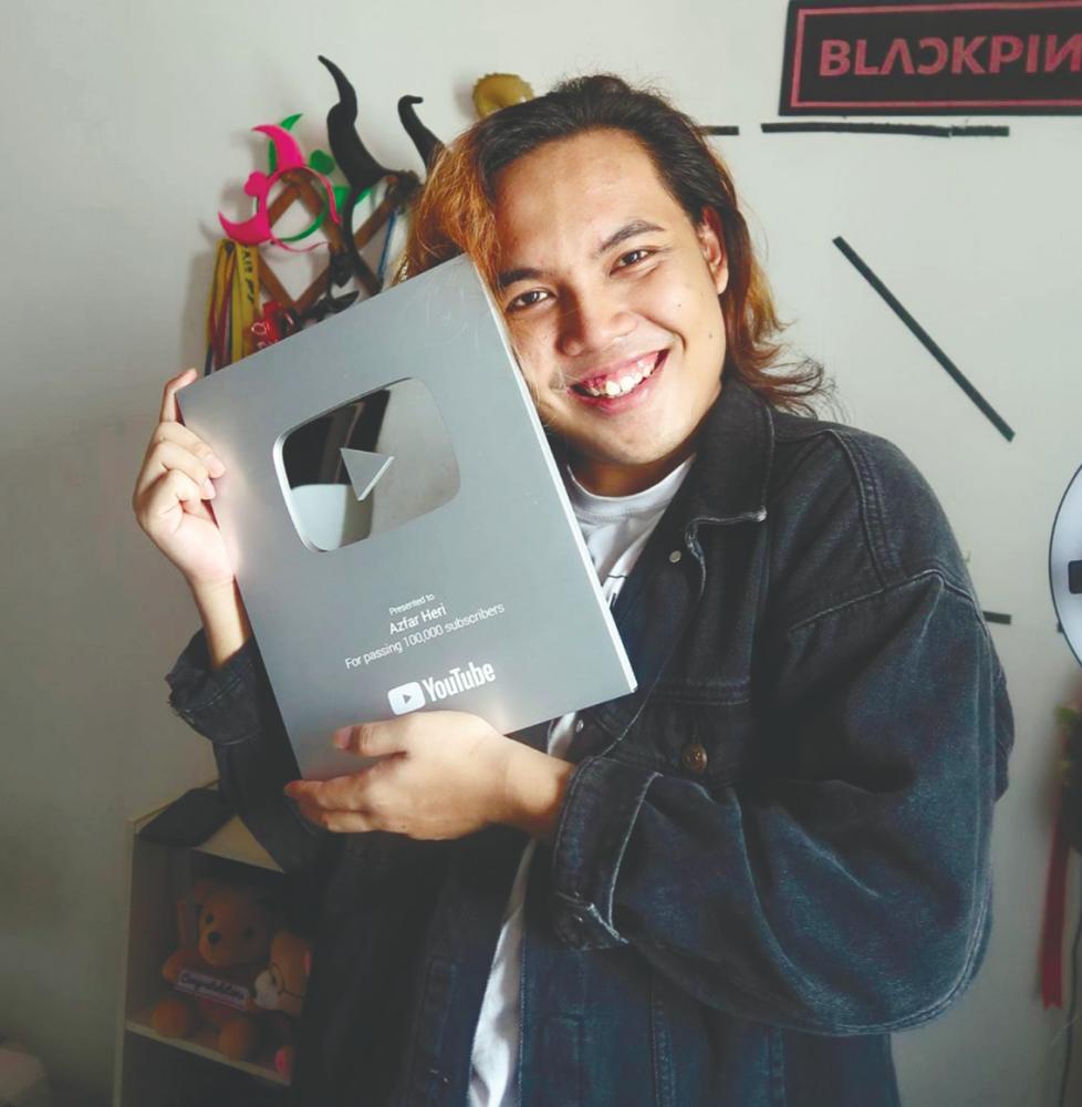 Azfar received his first YouTube play button for surpassing 100,000 subscribers. – Courtesy of Azfar Heri’s Instagram