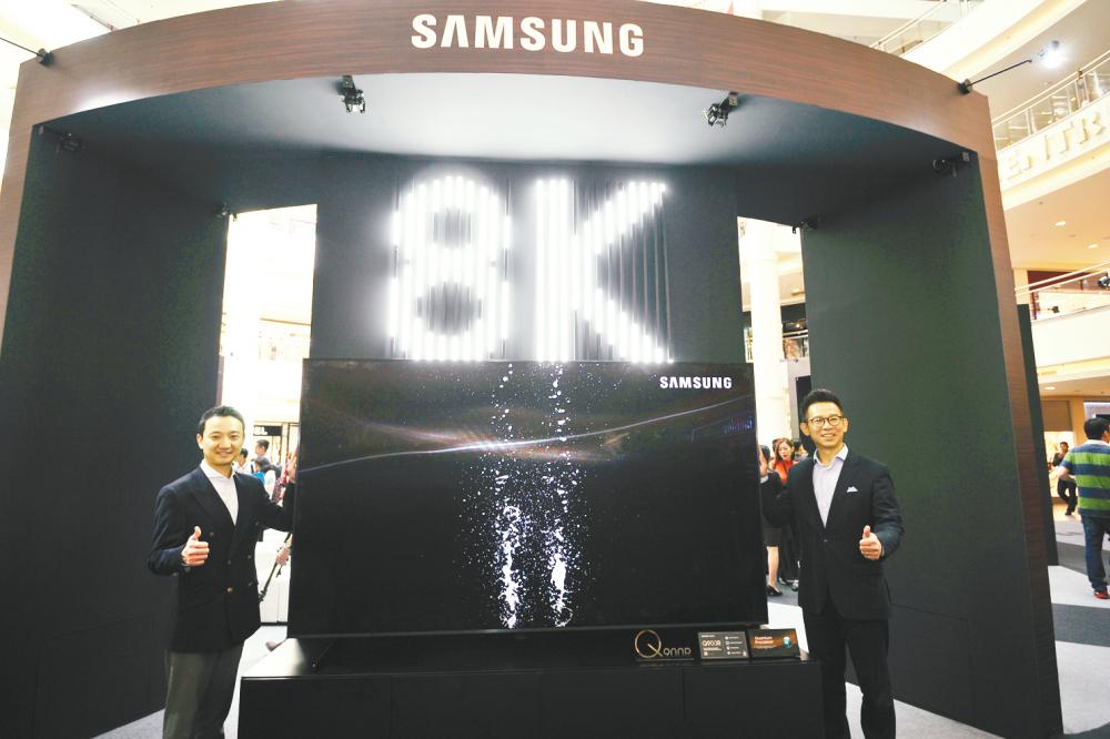 At the launch ... Sung and Tan showcasing the RM299,999 98in Q900R model. – Asyraf Rasid/theSun &amp; Samsung
