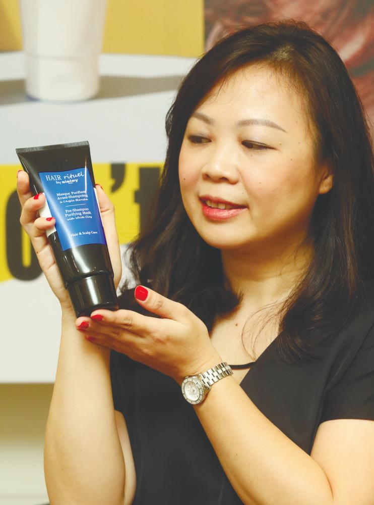 Sisley Cosmetics general manager Jacqueline Chen with the Pre-Shampoo Purifying Mask. - MASRY CHE ANI/THESUN