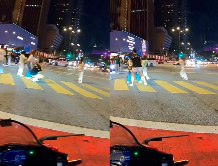 Selfish tourist poses in the middle of KL road for photo, annoys motorists