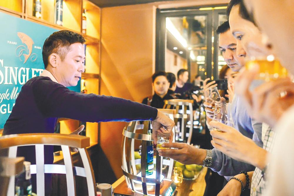Jeremy Lee (left) guided the guests through an exclusive whisky tasting event.