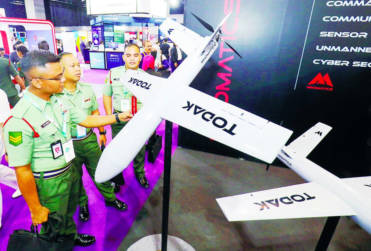 Army personnel examine a bomber drone developed by a local defence tech company during the event. – Adib Rawi Yahya/theSun