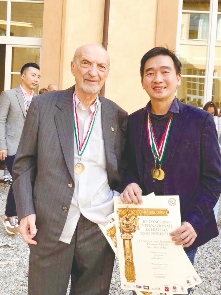 (left) Tan posing with Nicolini in Sesto Fiorentino, with his gold medals and certificates; and (below) his award-winning violin Negaraku and viola Jalur Gemilang. – TAN CHIN SENG