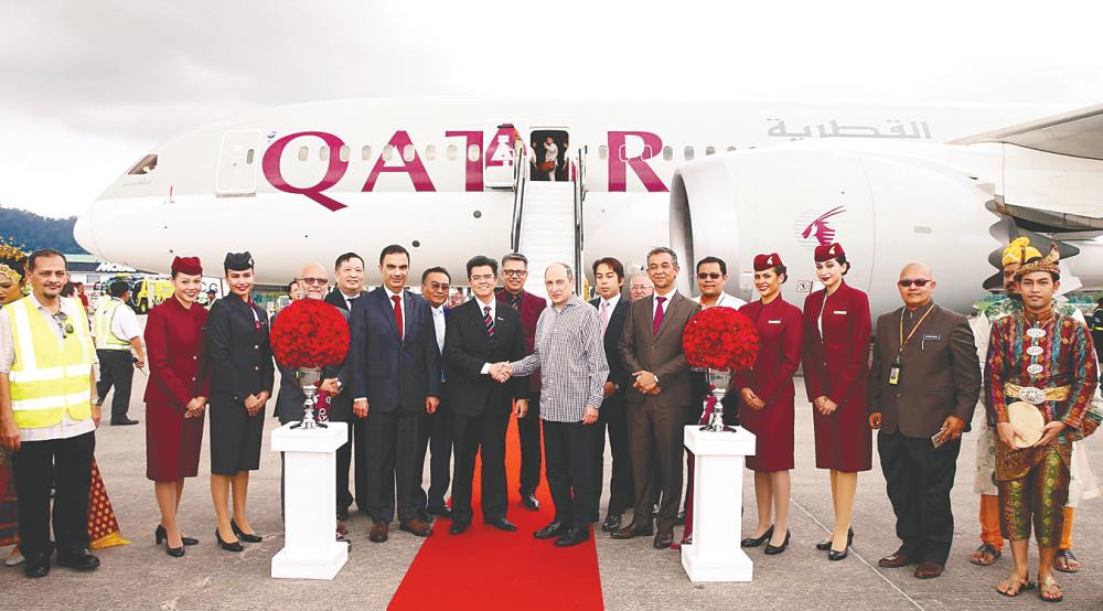 Qatar Airways Group chief executive officer Akbar Al Baker (front row in grey) shaking hands with Malaysia Airport Holdings chief operating officer Datuk Mohd Shukrie Mohd Salleh at the welcoming ceremony. – QATAR AIRWAYS