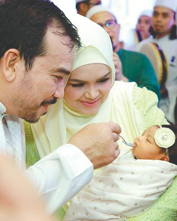 Siti Nurhaliza and husband Khalid with their long-awaited child, Siti Aafiyah.