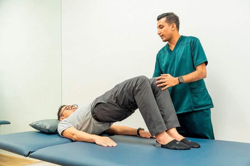 $!An AmHope physiotherapist administering rehab on a patient.