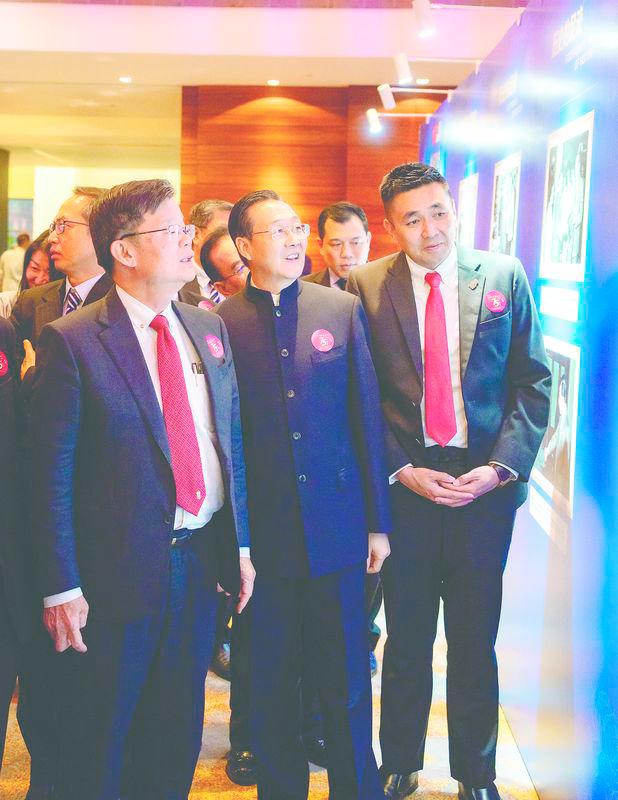 Chow (left) and Zhou (centre) viewing displays at an exhibition held during the event. – PIC COURTESY OF CHINA CONSULATE GENERAL