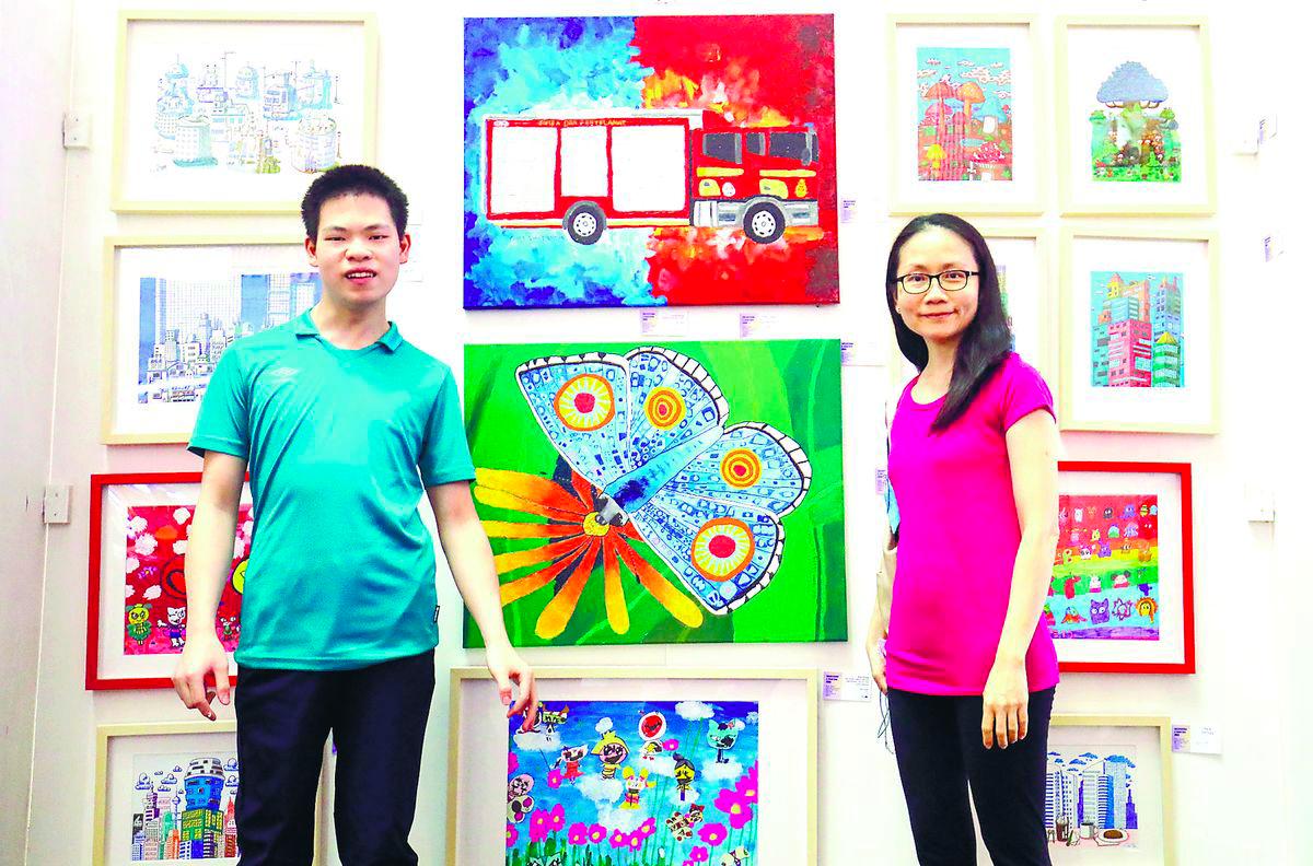 Tay and Sheng at their display booth during the exhibition. – Adib Rawi Yahya/theSun