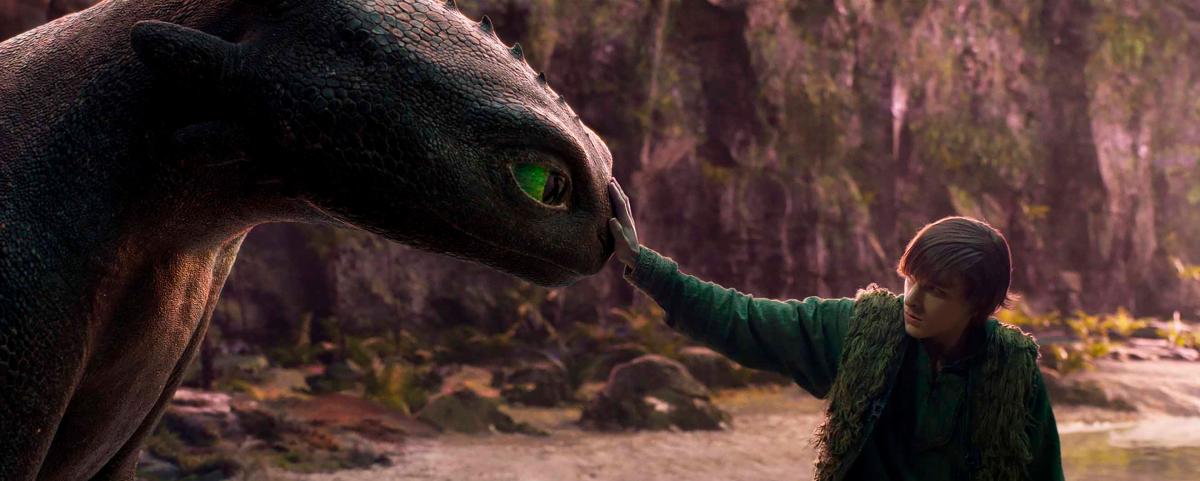 Hiccup (Thames) shares a quiet moment with Toothless in a breathtaking live-action reimagining of their iconic bond.