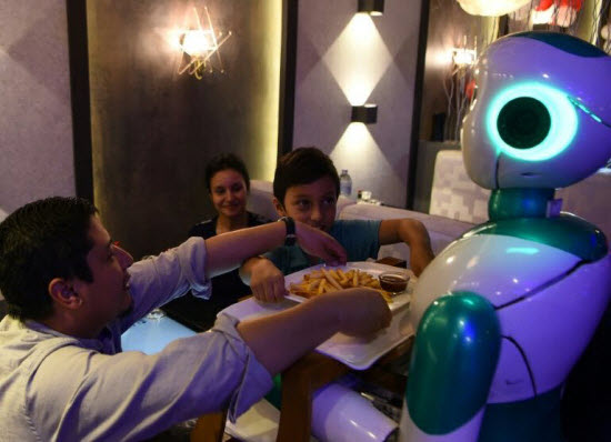 This humanoid robot named Ginger is one of three locally-built machines to serve customers at a restaurant in the capital of impoverished Nepal. — AFP