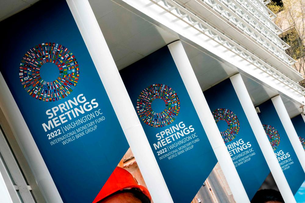 Signs for the IMF’s annual spring meetings are displayed outside the World Bank headquarters in Washington DC yesterday. The IMF says close collaboration with the World Bank and other international financial institutions wil be critical for the success of the Resilience and Sustainability Trust. – AFPpix