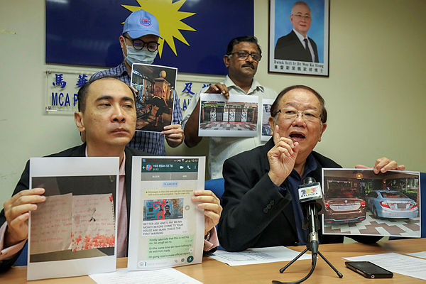 Public Services and Complaints Department head Datuk Seri Michael Chong showing pictures of threats made by ah longs to innocent victims, at a press conference in Kuala Lumpur, on July 10.