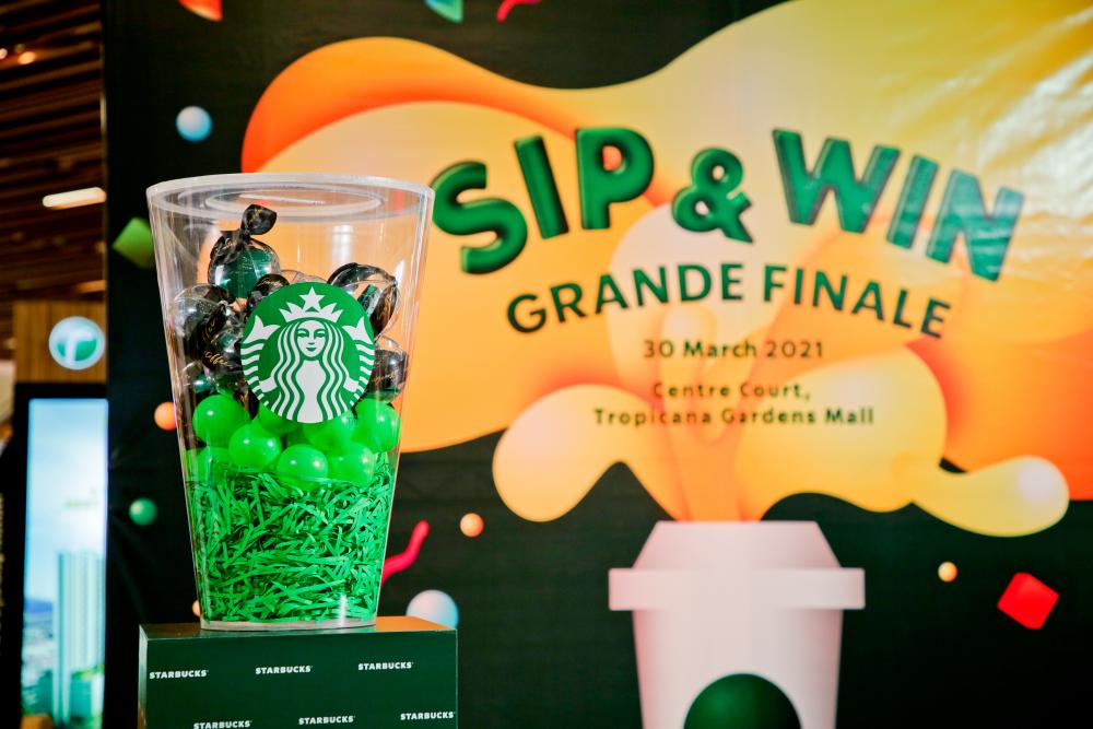 A giant replica of the well-known Starbucks cup was used to draw the names of the Starbucks Sip and Win contest finalists.