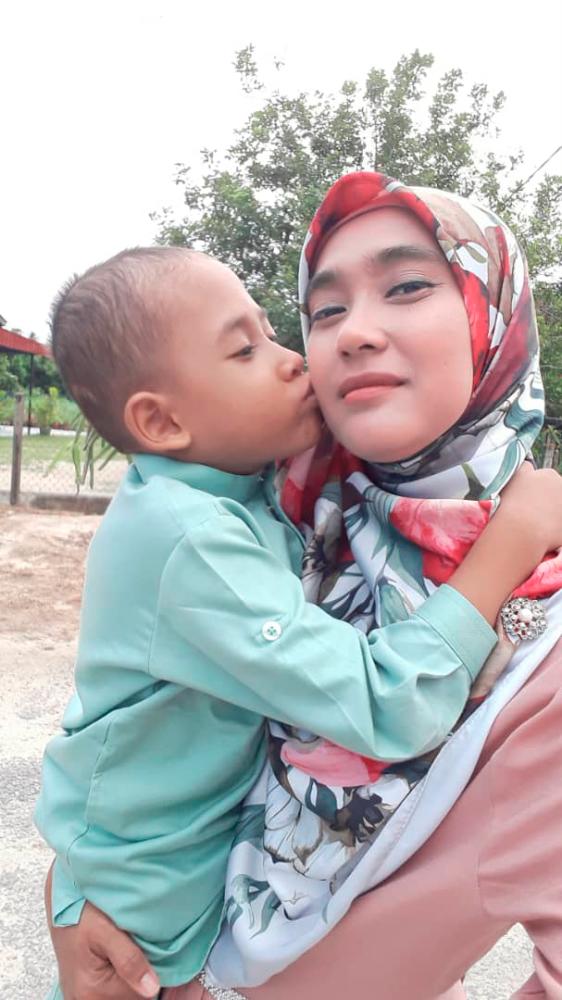 Caption: Muhammad Irham Itqan Shaiful Azli, born with spina bifida and encephalitis, is able to walk with the help of a knee ankle foot orthosis. At the beach side in Kuantanwith his mother Norkhairina Sh Ab Hamid.