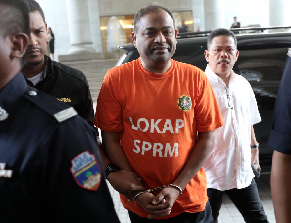 Umno Baling MP and former Tabung Haji chairman Azeez Abdul Rahim being escorted by MACC officers to the court in Putrajaya for a remand order on Sept 26, 2018. — Sunpix by Norman Hiu