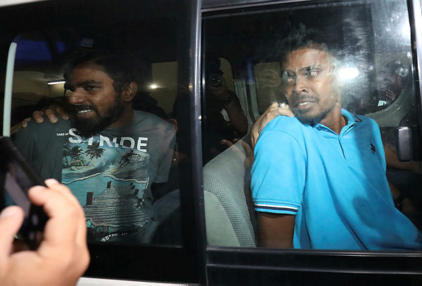 Storekeeper, S. Thanagaraj, 26 (right) and security guard, M. Pumugan, 29 (left), were charged in Butterworth Sessions Court today for possessing items linked to the LTTE terrorist group. — Bernama