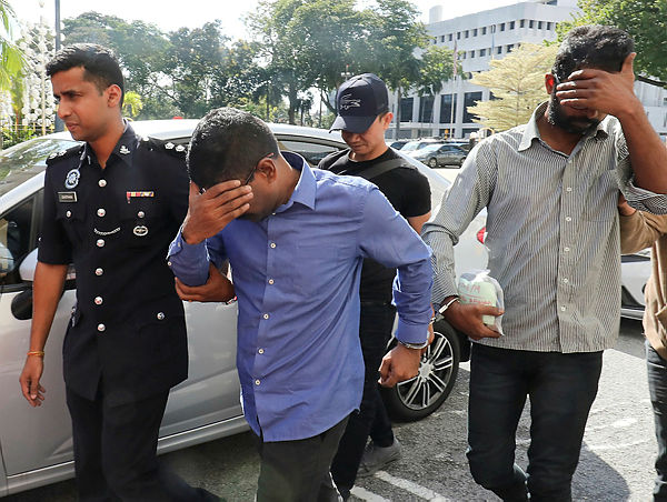 The two famous nasi kandar restaurant staff in Bukit Jambul being led by police to obtain a 7 day remand order against them after lodging false police report that the eatery’s three day’s takings worth RM122,555 were robbed by armed robbers — Sunpix by Masry Che Ani