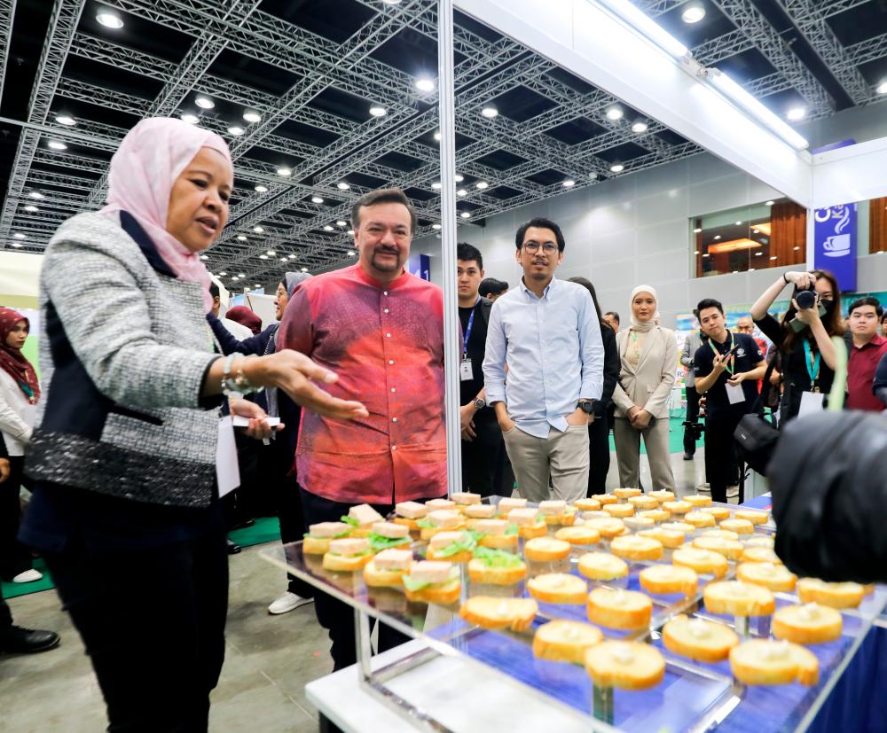 Amir Hamzah (second left) and Norlela (left) visiting a booth at the fair held in Kuala Lumpur yesterday. – THESUNPIX