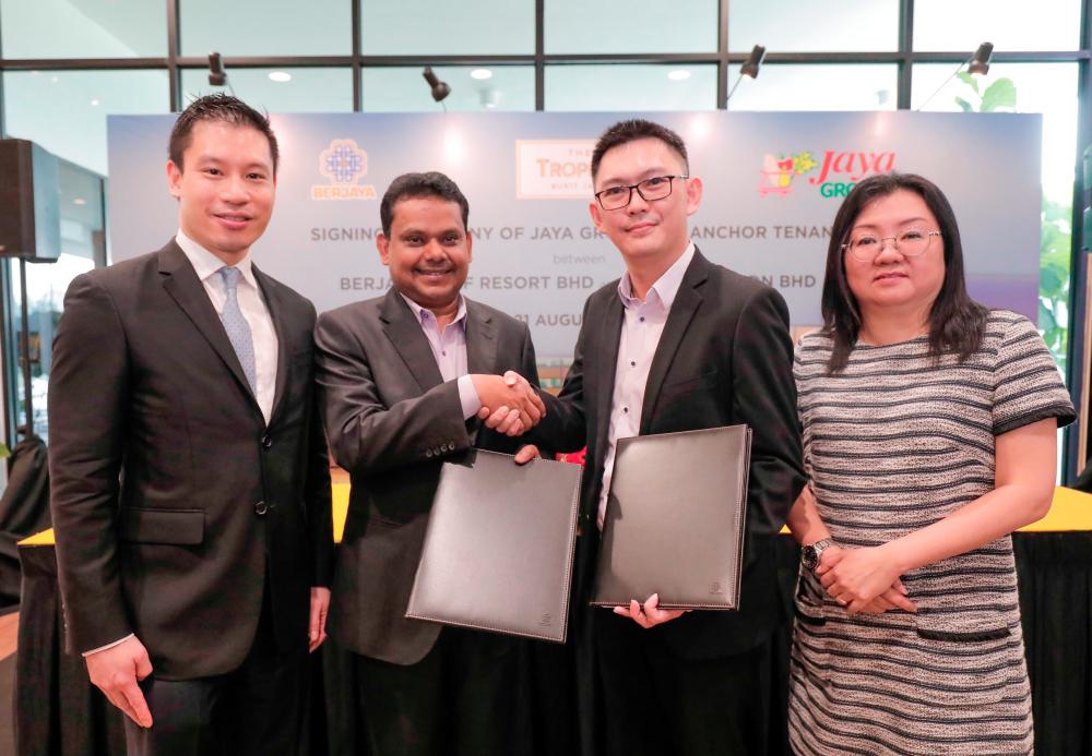 BLand CEO Syed Ali Shahul Hameed (second from left) exchanging documents with Trendcell CFO Chong Han Keong at the signing ceremony. Looking on are BLand senior general manager of property sales and marketing division Tan Tee Ming (left) and Trendcell head of department, advertising and promotions Ho Yong Pheng. - Ashraf Shamsul/THESUN