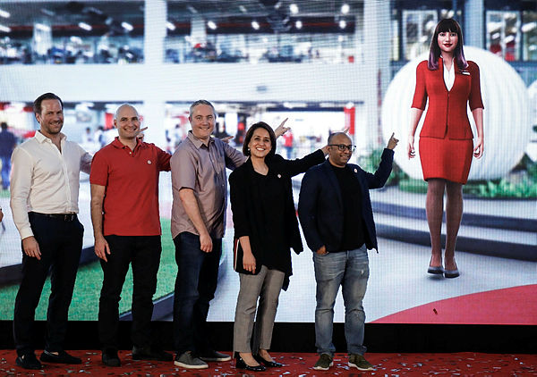(L to R) AirAsia head of Airline Product &amp; Product Transformation Bo Kenneth Andersson, Group Head of Software Engineering, Elias Vafiadis, Customer Happiness Officer Adam Geneave, AirAsia Deputy Group CEO (Digital, Transformation and Corporate Services) Aireen Omar, and chief product officer Nikuni Shanti show off the AVA chatbot. — Sunpix by Ashraf Shamsul