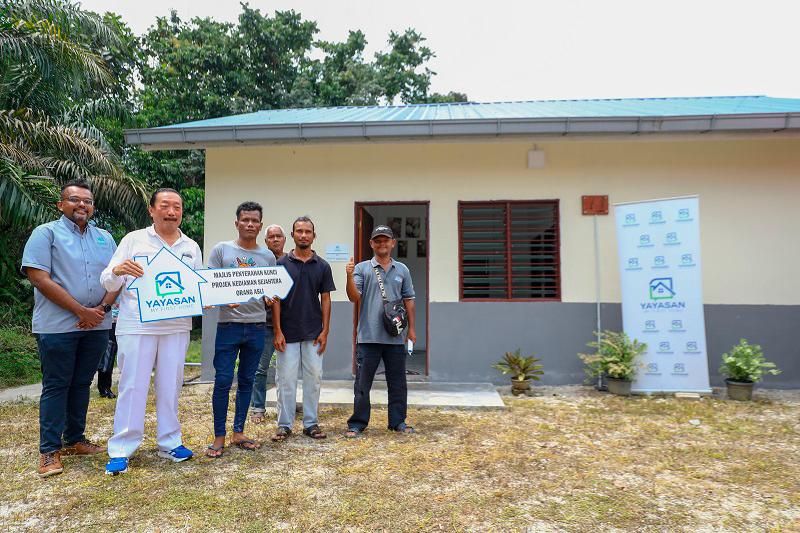 Tan (in white) during the key presentation ceremony yesterday with (from left) Nambee, Bah Juga, Bah Tian and village head Sani. – AMIRUL SYAFIQ/THESUN