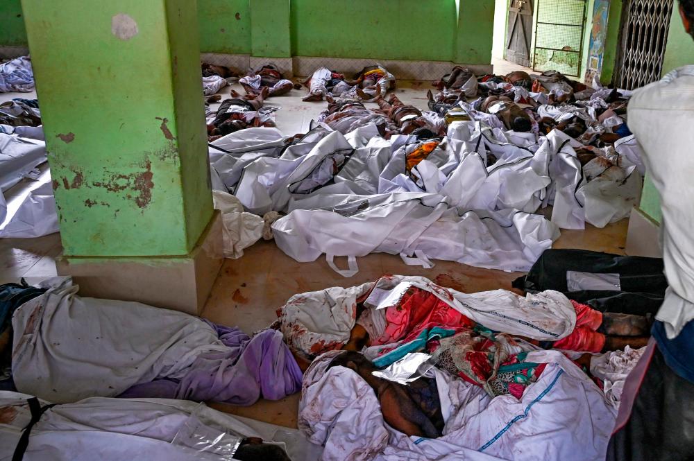 Graphic content / Bodies are seen at a high school used as temporary mortuary to identify the dead recovered from a carriage wreckage of a three-train collision near Balasore, in India’s eastern state of Odisha, on June 3, 2023/AFPPix