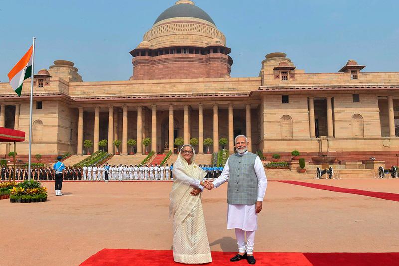 This handout photograph taken and released on June 22, 2024 by the Indian Press Information Bureau (PIB) shows India's Prime Minister Narendra Modi shaking hands with Bangladesh's counterpart Sheikh Hasina (L) after receiving her at the Presidential Palace Rashtrapati Bhavan in New Delhi on June 22, 2024. - AFP PHOTO /Indian Press Information Bureau (PIB)