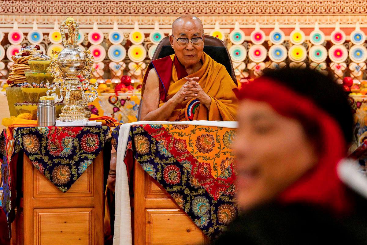 Tibetan spiritual leader the Dalai Lama looks on as offerings presented by Buddhist followers are laid on a table during a Long Life Prayer offering ceremony at the Main Tibetan Temple in McLeod Ganj, near Dharamsala on June 30, 2025. - AFPPIX