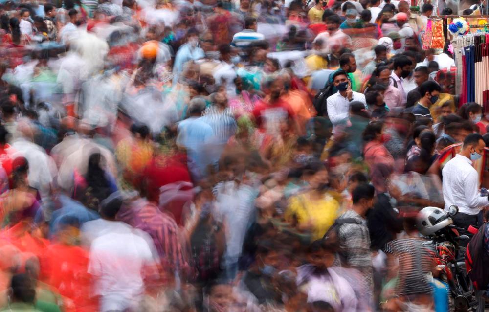 A man speaks on the phone as people walk past him at a crowded market amidst the spread of the coronavirus disease (Covid-19) in Mumbai, India, September 5, 2021. REUTERSpix