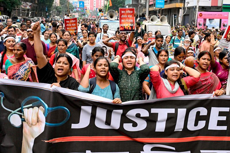 Doctors and social activists carrying a banner, shout slogans during a rally to condemn the rape and murder of a doctor in Kolkata on October 2, 2024. Tens of thousands of people packed the streets of one of India's biggest cities after doctors resumed a strike and called fresh rallies over the rape and murder of a colleague. - AFPpix