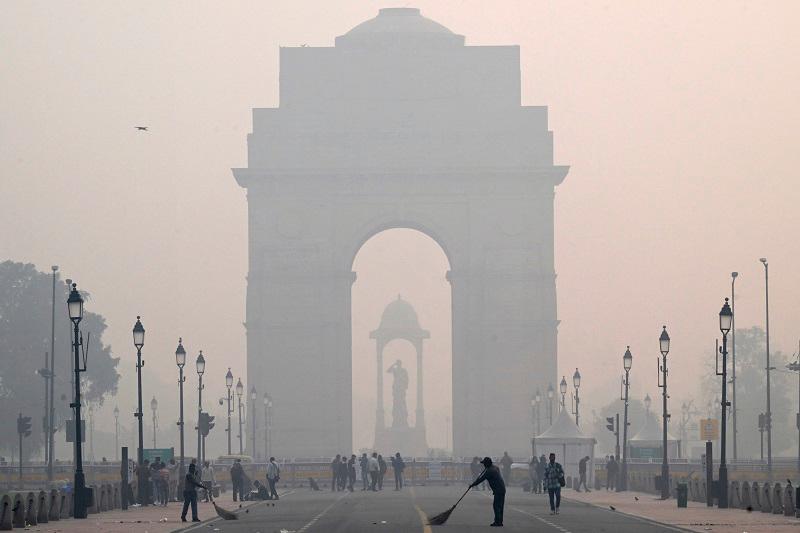 Workers clean the Kartavya Path in front of the India Gate amid heavy smoggy conditions in New Delhi on November 13, 2023. Delhi regularly ranks among the most polluted major cities on the planet, with a melange of factory and vehicle emissions exacerbated by seasonal agricultural fires. - Sajjad HUSSAIN / AFPpix