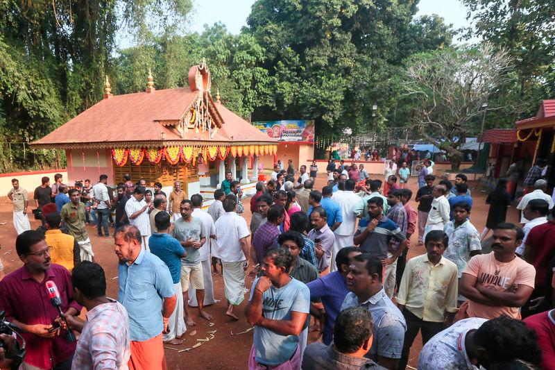 People gather after firecrackers explosion at the Anjootambalam Veererkavu temple in Kasaragod district of Kerala on October 29, 2024. - AFPPIX