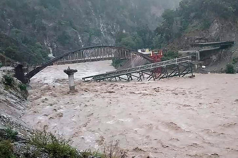 An under construction bridge is seen collapsed on a river along a national highway between Pithoragarh-Champawat, in Chalthi on October 19, 2021 following heavy rainfalls in northern India. AFPpix