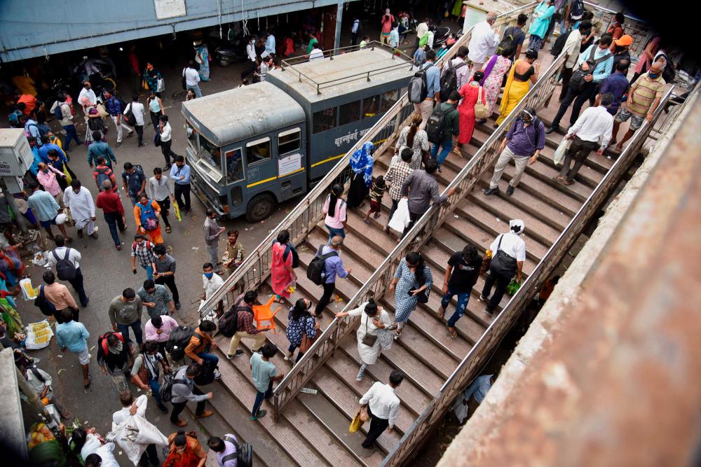 People crowd at a railway station in Mumbai on April 12, 2021, as India overtook Brazil as the country with the second-highest number of Covid-19 coronavirus infections. –AFP
