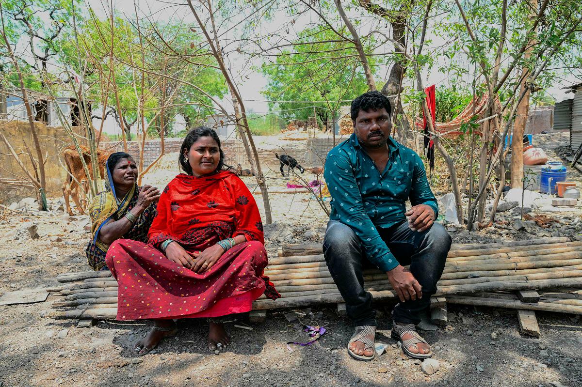 In this photograph taken on May 4, 2025, Manisha Barde (C), a sugarcane worker who was married as a child bride, is pictured along with her husband, Balu Somnath Barde (R), near their home at Umrad Khalsa village in Beed district of India’s state of Maharashtra. When wedding season comes in India, the phone of child rights activist Tatwashil Kamble never stops ringing with appeals to stop girls from being married off due to poverty. India accounts for one in three of the world’s child brides, according to the UN children’s agency, with at least 1.5 million girls getting married each year. - Indranil MUKHERJEE / AFP