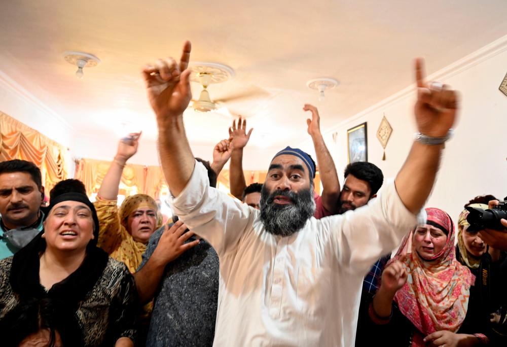 Relatives of Bashir Ahmed, a civilian who died during a gun-battle between government forces and suspected militants, shout pro-freedom and anti-India slogans at Bashir's home during his funeral in Srinagar on July 1,2020. Hundreds of angry residents in Indian-administered Kashmir on July 1 protested accusing government forces of killing a man during a rebel attack which also left a paramilitary trooper dead and four injured, officials said. — AFP