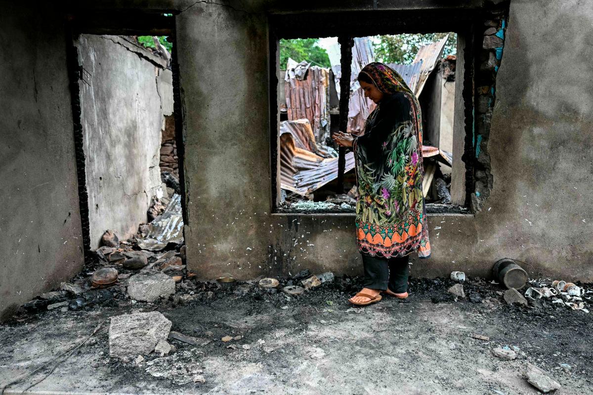 A woman stands outside her house destroyed by Pakistani artillery shelling at the Salamabad village in Uri, about 110kms from Srinagar, on May 8, 2025.AFPpix