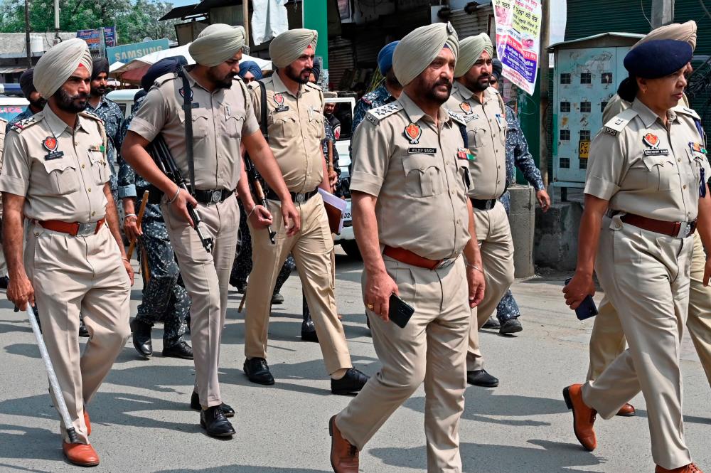 Punjab Police personnel patrol in the village Jallupur Khera about 45 km from Amritsar on March 19, 2023. A manhunt for a radical Sikh preacher in India entered its second day on March 19, after authorities shut mobile internet in the whole of Punjab state and arrested 78 of his supporters. AFPPIX