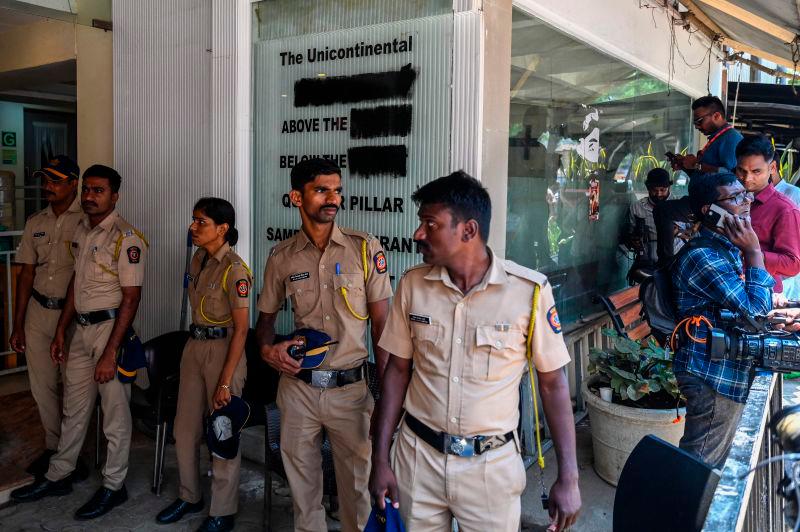 Police and media personnel stand outside the building of a studio that was ransacked by Shiv Sena party workers a day earlier, in Mumbai on March 24, 2025 AFPpix