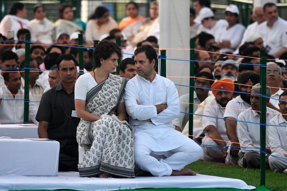 This handout photograph released by the AICC (All India Congress Committee) Communication Department on May 21, 2019, shows Congress president Rahul Gandhi (R) speaking with his sister Priyanka Gandhi Vadra, the Congress general secretary for eastern Uttar Pradesh. - AFP
