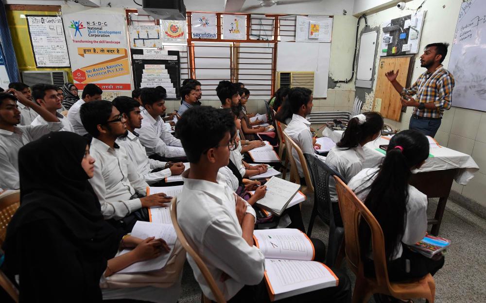 This photo taken on May 22, 2019, shows Indian youths at a class for a three-month course on computer hardware at a training centre run by the National Skill Development Corporation (NSDC) under the Ministry of Skill Development and Entrepreneurship (MSDE) in New Delhi. - AFP
