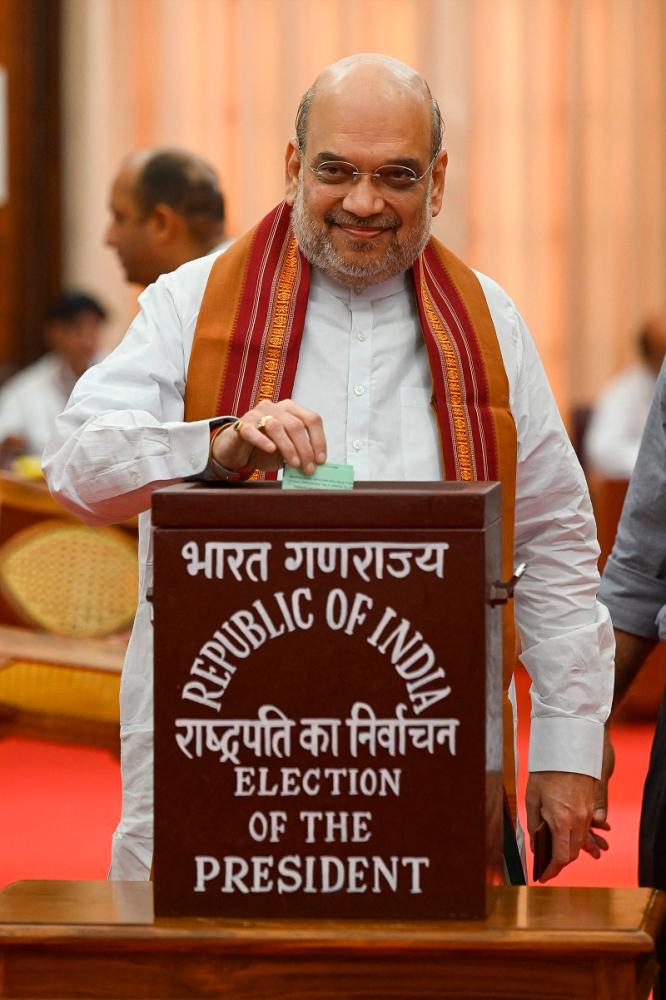 India Home Minister Amit Shah votes to elect the next Indian president at Parliament House in New Delhi on July 18, 2022. India's parliament began voting on July 18 for a new president, with a female politician from the country's marginalised tribal community the favourite for the post. - Prakash SINGH / AFP