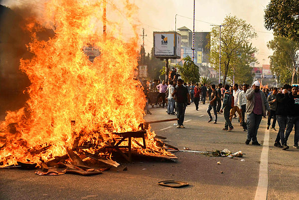 Demonstrators setup a bonfire on a street as they protest against the governments Citizenship Amendment Bill (CAB), in Guwahati on Dec 11, 2019. Authorities in India’s northeast called in troops on Dec 11 as demonstrators went on the rampage in protest at new citizenship legislation expected to pass the upper house, officials said. — AFP