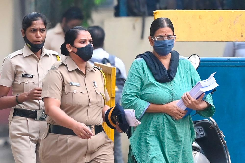 Police escort activist Sudha Bharadwaj (R) towards a van as she leaves jail to appear in a special court ahead of her release on bail on the 2018 Bhima Koregaon case in Mumbai on December 8, 2021. AFPpix