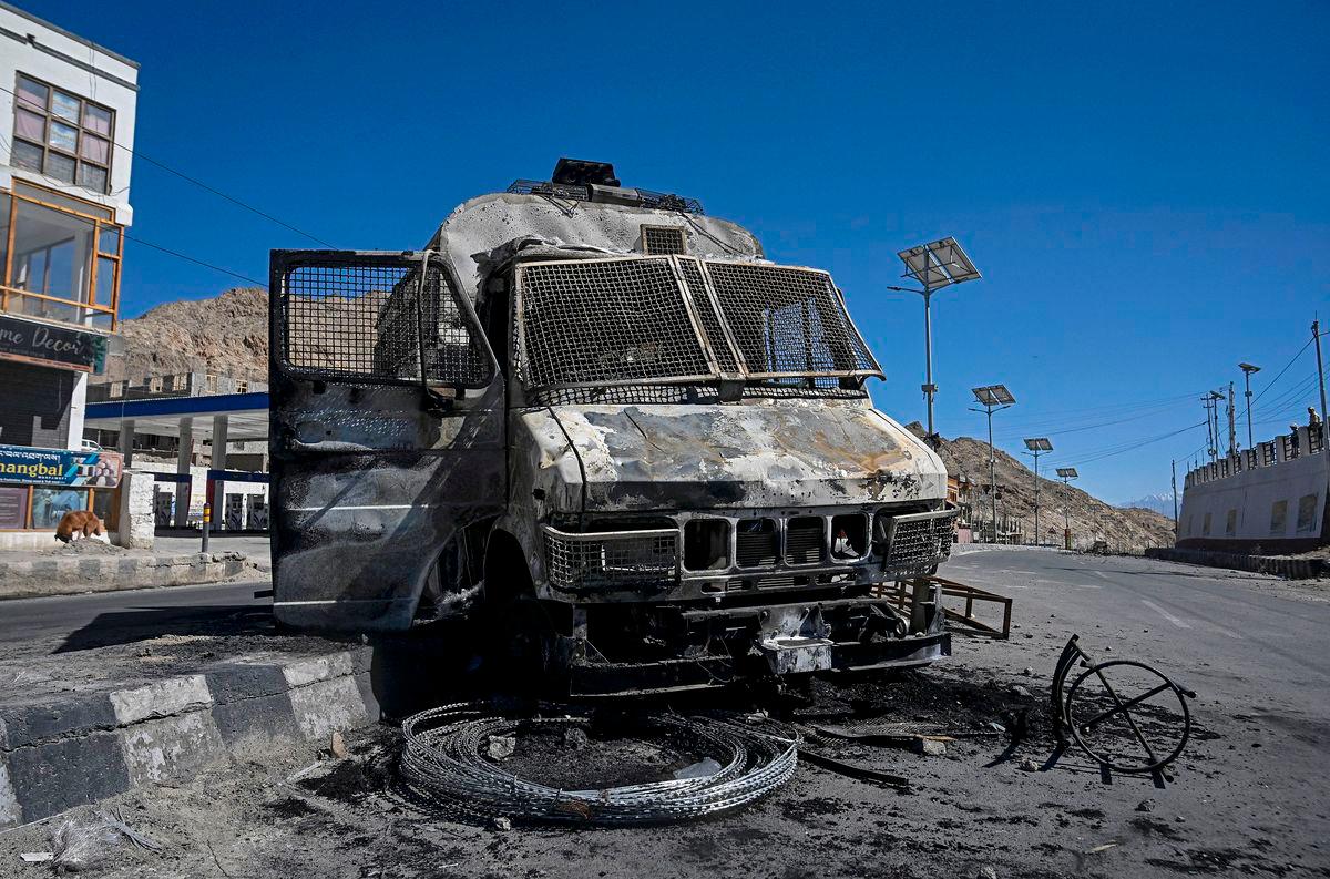A burnt police vehicle is pictured that was torched by the demonstrators near the Bharatiya Janata Party (BJP) office in Leh on September 25, 2025. (Photo by Tauseef MUSTAFA / AFP)